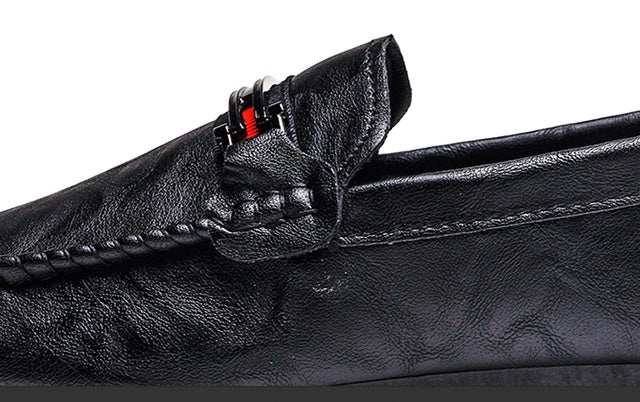 Black moc-toe slip-on loafer showing stitched vamp and side strap detail