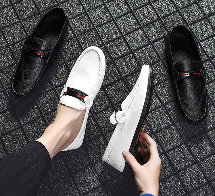 White and black moc-toe slip-on loafers with red/gray strap detail