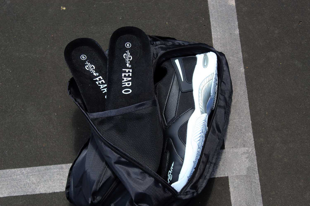 Black men's walking sneakers partially shown with shoe bag and inner lining