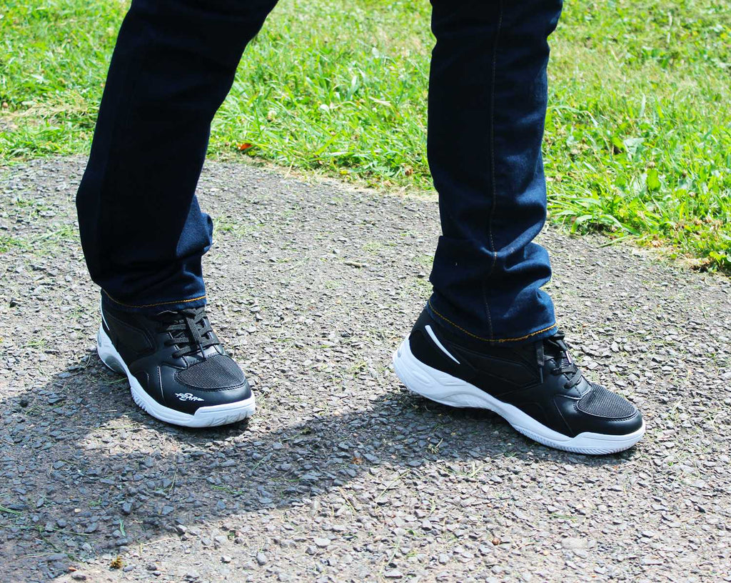 Black men's walking sneakers, angled view with lace-up closure and white soles