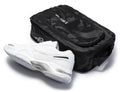 Men's white walking sneakers with black shoe bag, showing side and sole tread