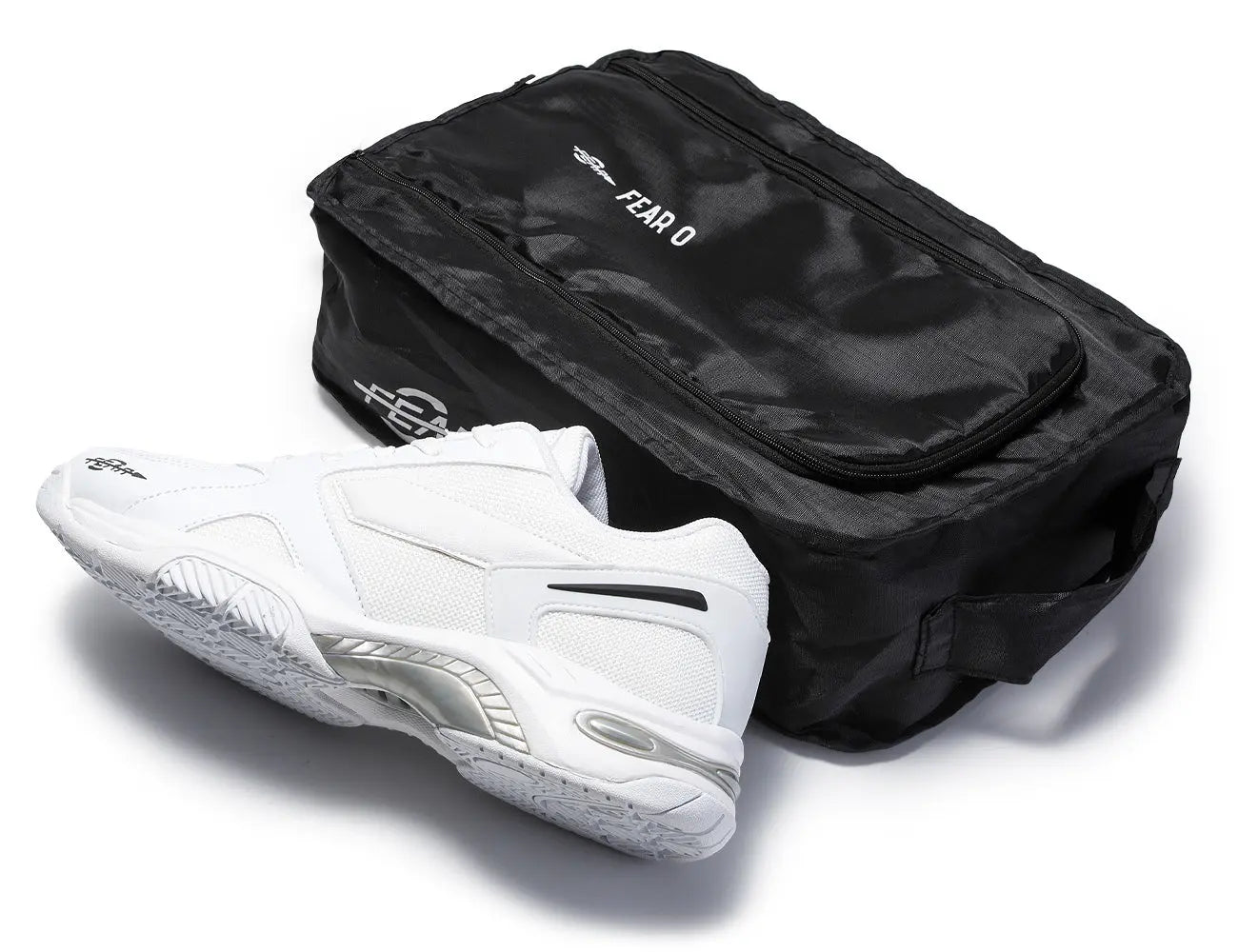 Men's white walking sneakers with black shoe bag, showing side and sole tread