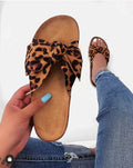 Leopard print bow slide sandals with bow detail on tan footbed