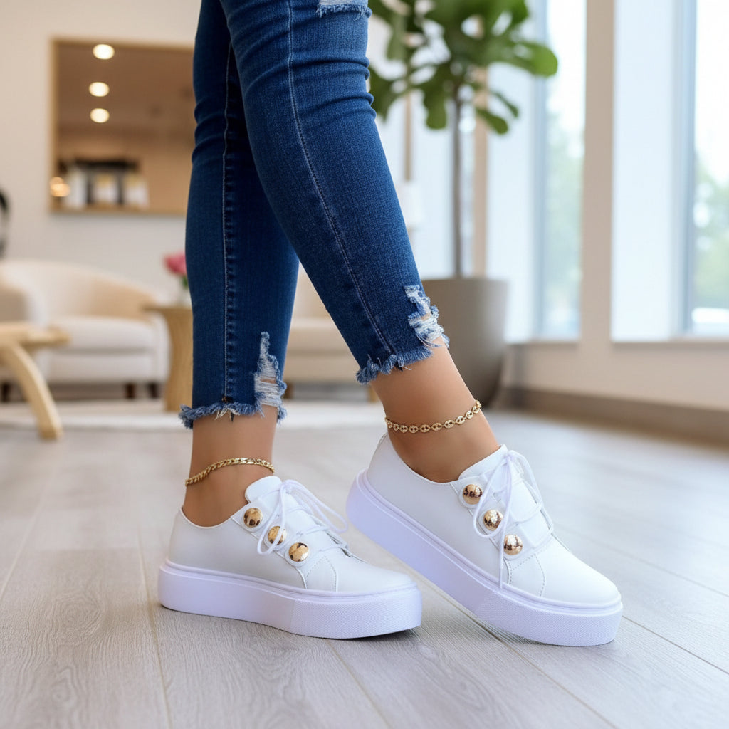 White platform sneakers, lace-up with gold toe studs, gold ankle chain