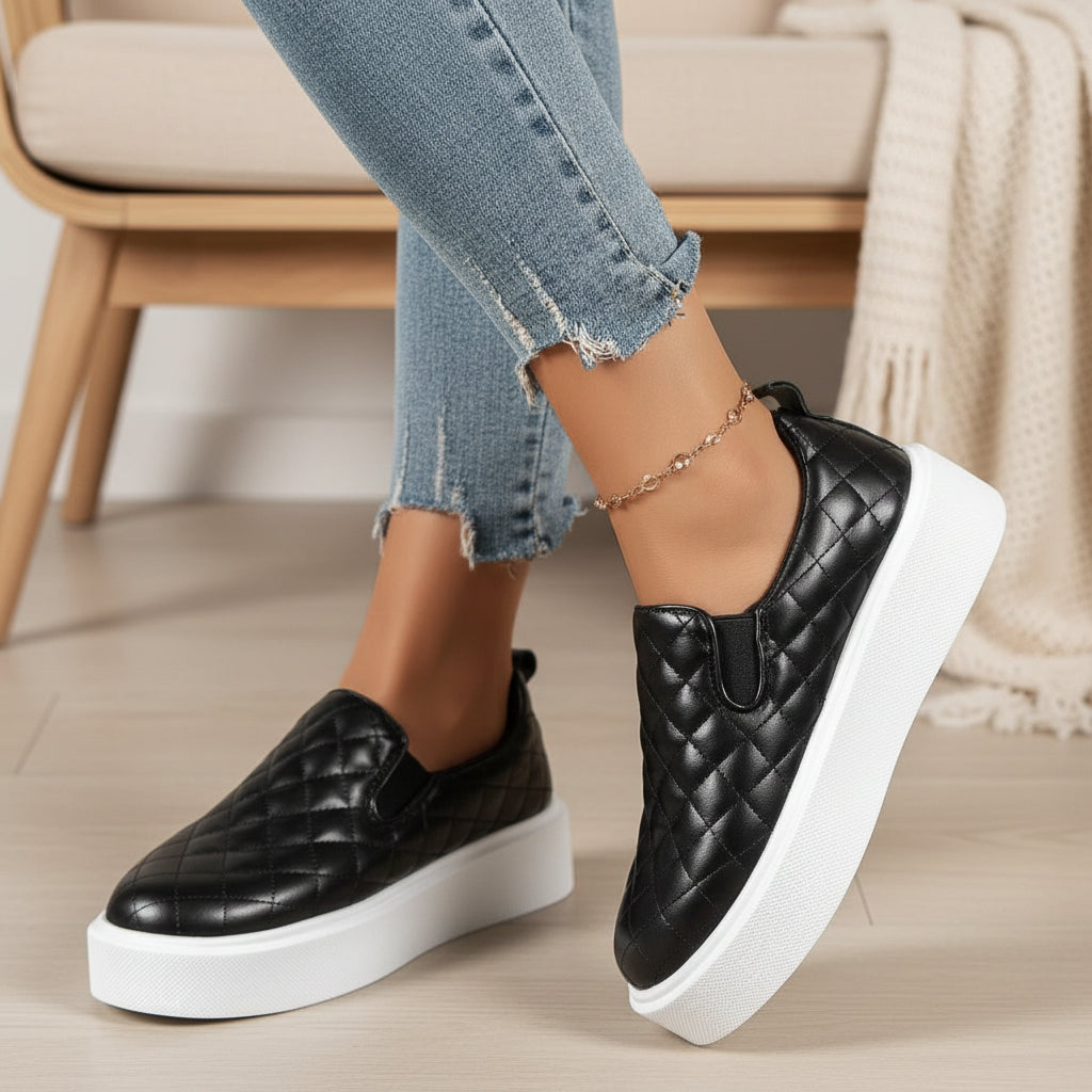 Black quilted slip-on sneaker with white platform sole and decorative collar