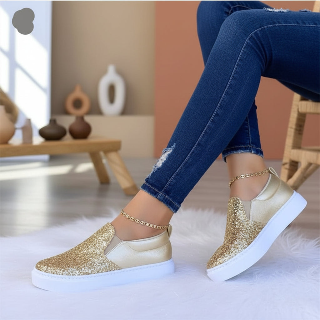 Women’s gold glitter slip-on platform sneakers with white rubber sole.