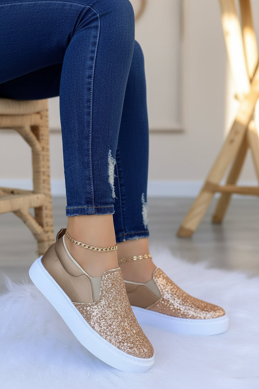 Women’s rose gold glitter slip-on platform sneakers with white sole.