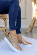 Women’s rose gold glitter slip-on platform sneakers with white sole.
