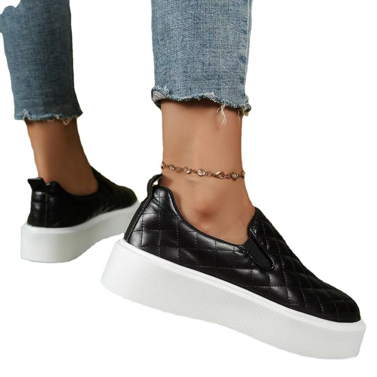 Black quilted slip-on platform sneaker with white sole, low profile