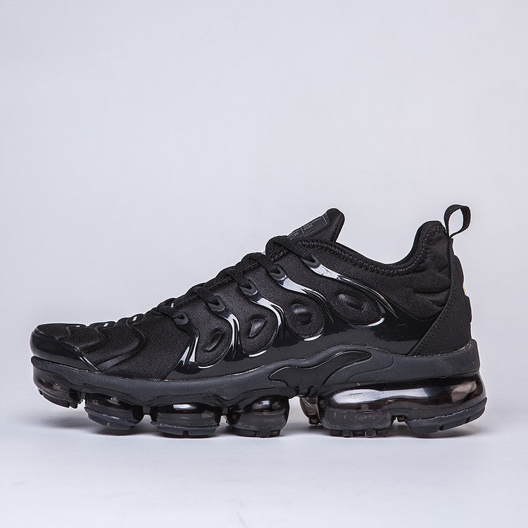 Black unisex sculpted-sole sneakers with wavy overlays and air-cushion sole pods.