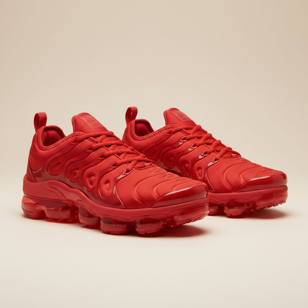 Red unisex sculpted-sole sneakers with molded overlays and air-cushion sole pods.