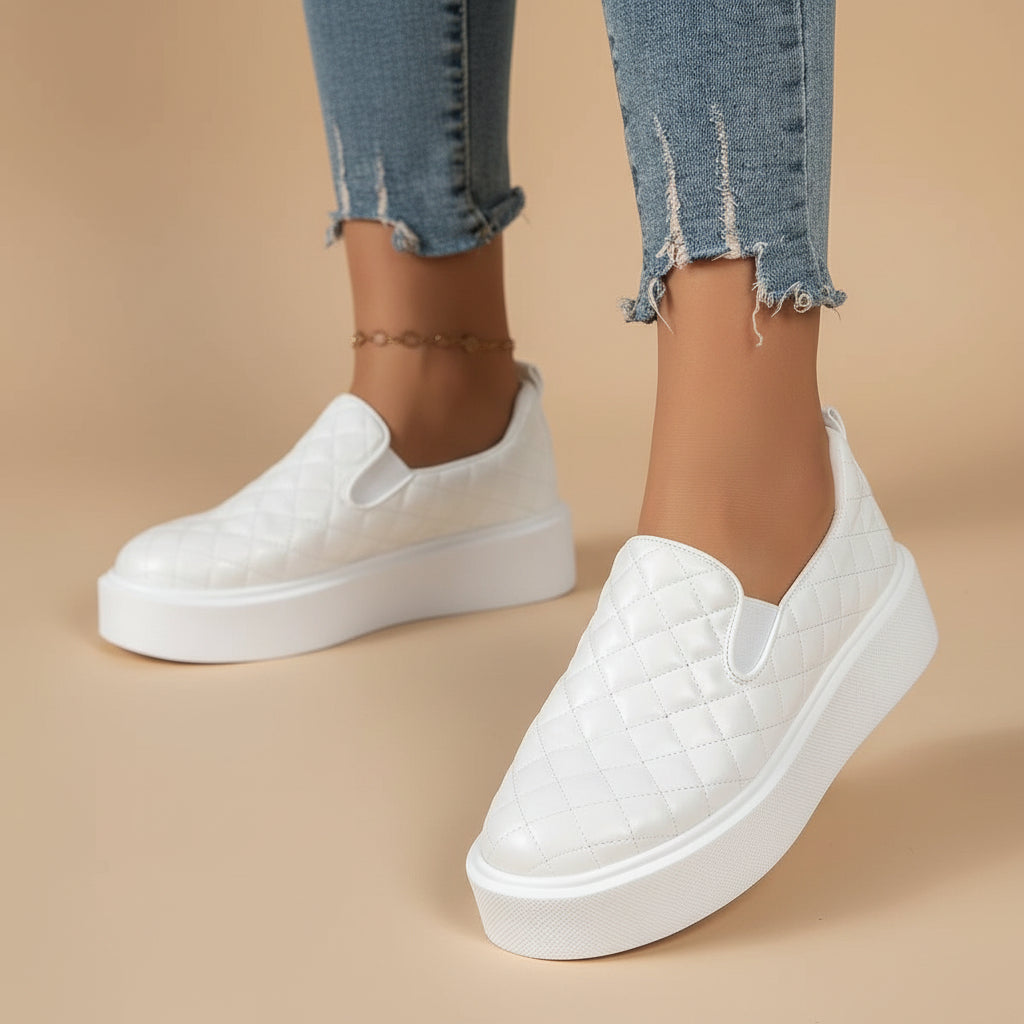 Quilted white slip-on platform sneaker with white sole and cushioned upper