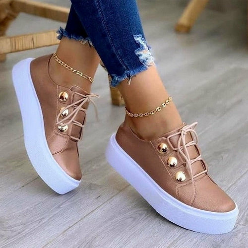 Rose platform sneakers with lace-up front, gold ankle chain, metallic toe studs