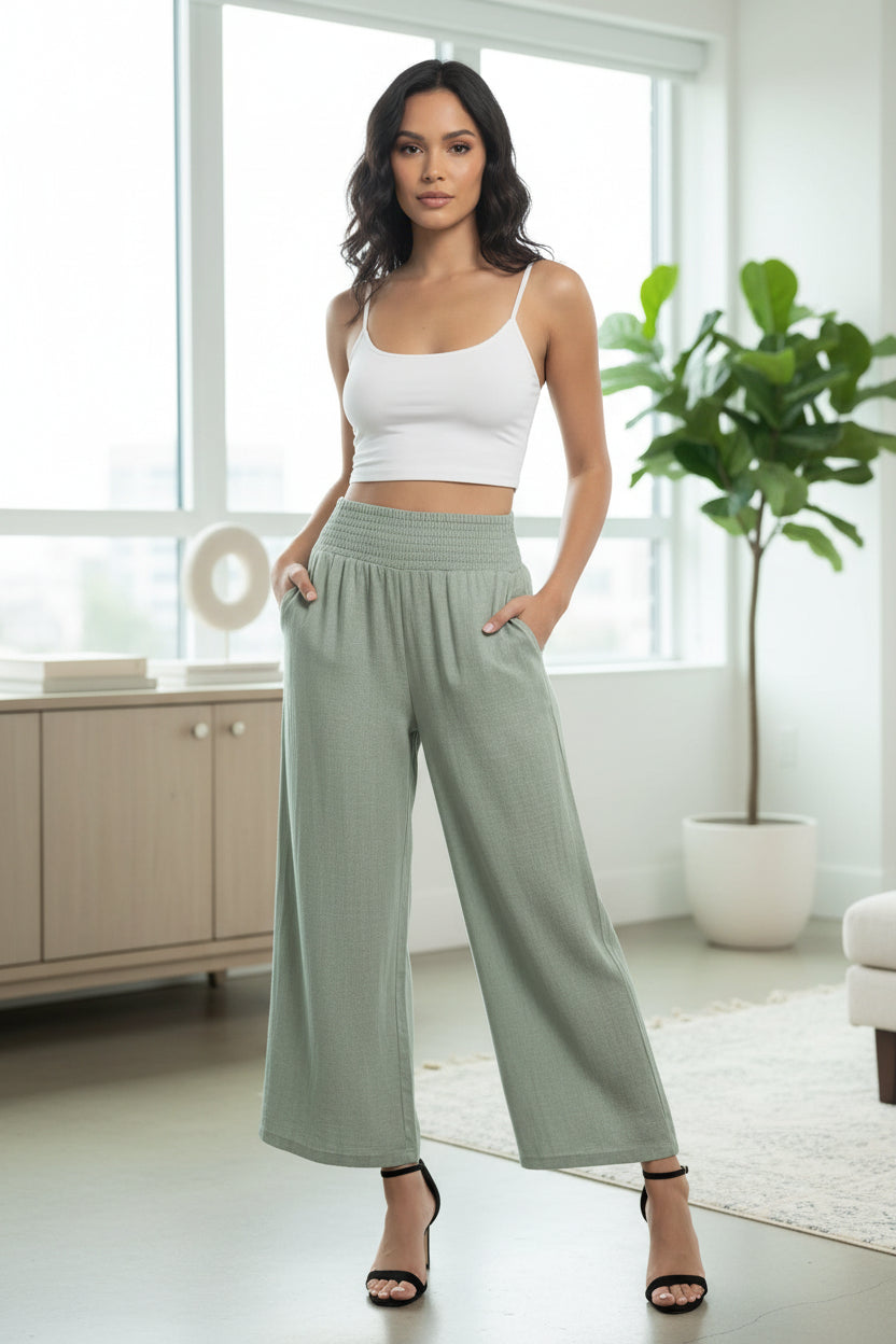 Back view of high-waisted wide-leg lounge pants in soft sage green with elastic waist