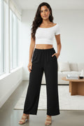 Black wide-leg cotton pants with elastic waist and side pockets