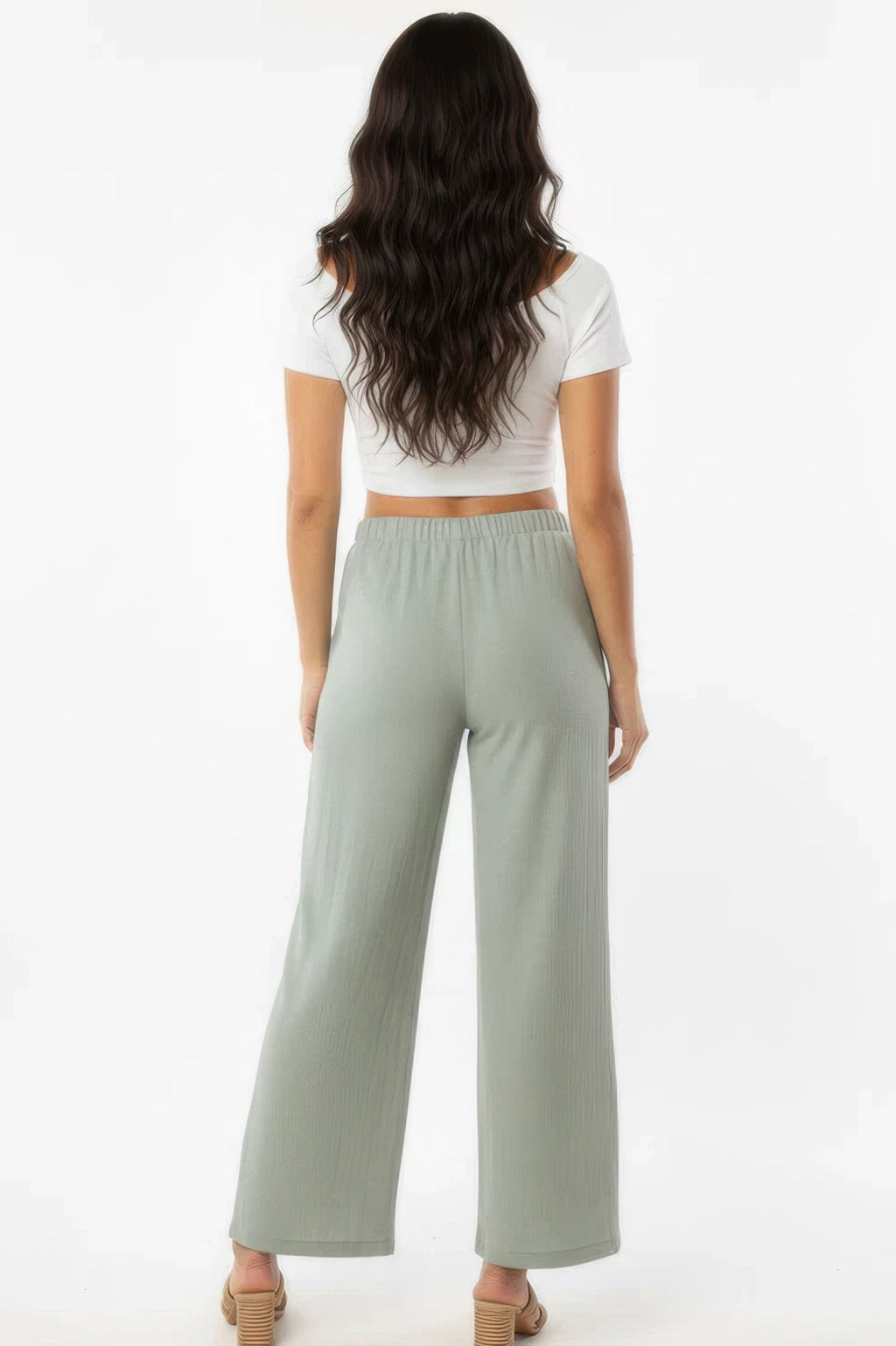 Sage wide-leg cotton pants, rear view with side pockets and elastic waist