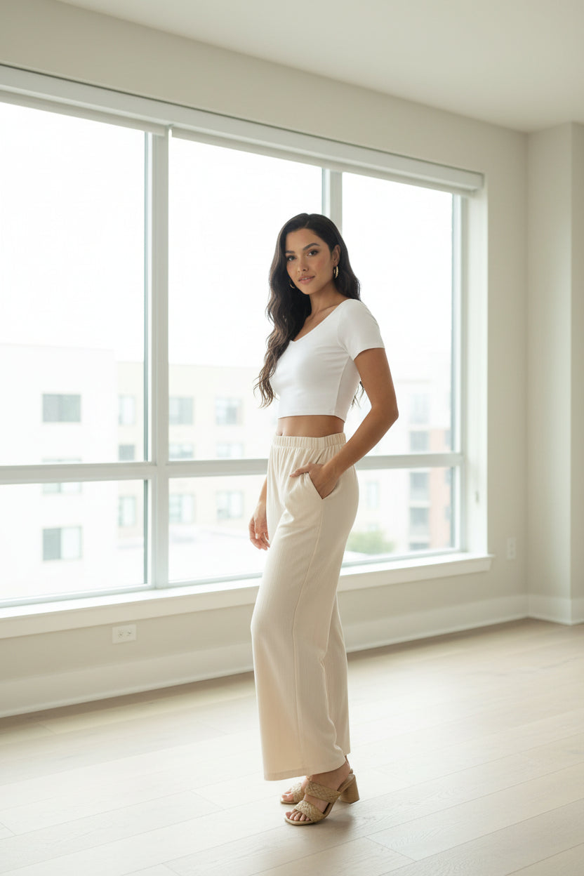 Off-white wide-leg cotton pants with elastic waist and side pockets