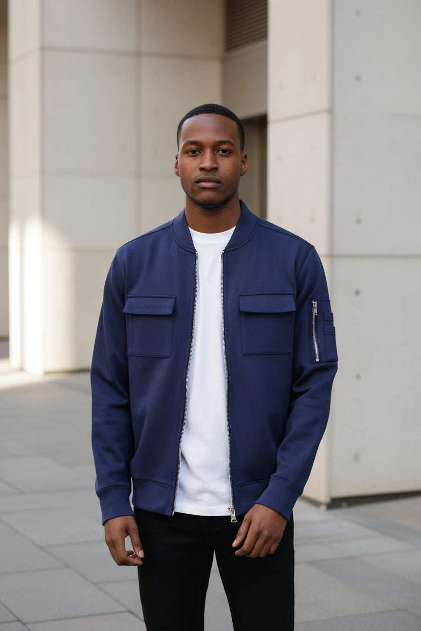 Men's navy cotton zip-front jacket with two chest pockets and ribbed cuffs