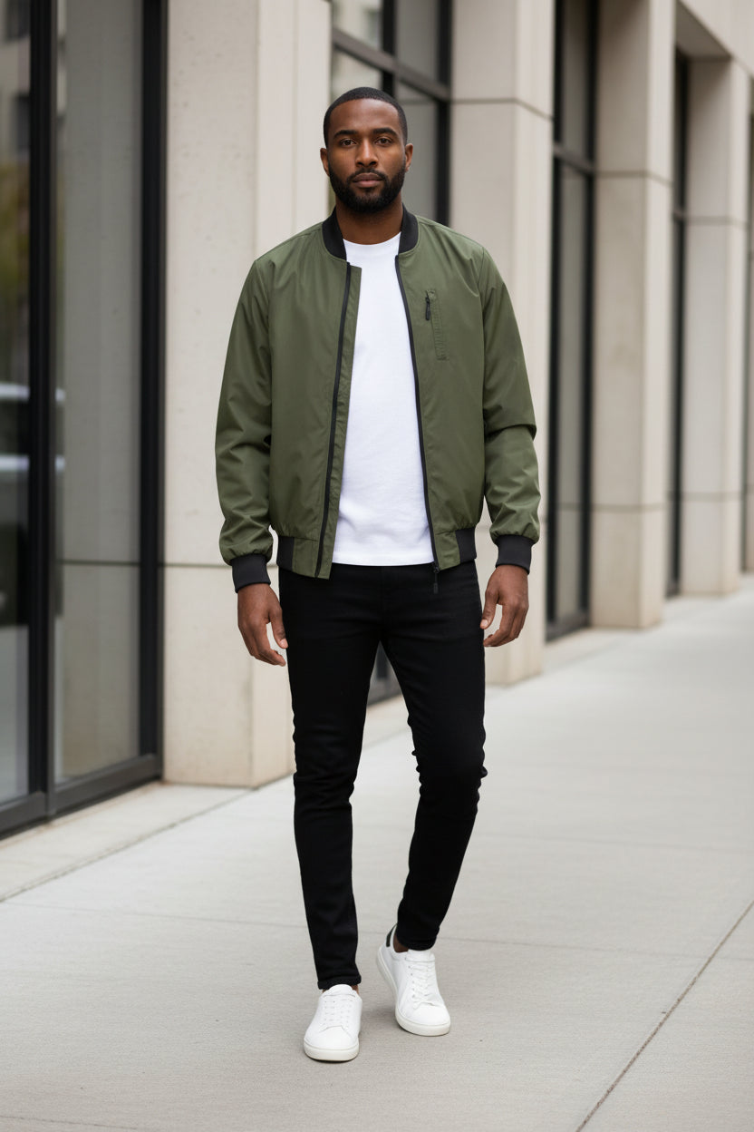 Lightweight olive windbreaker jacket with black ribbed cuffs and front zip
