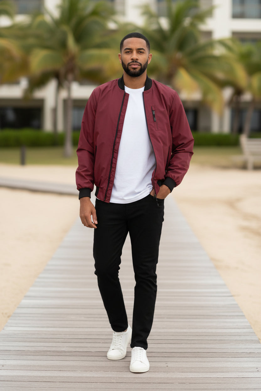 Lightweight burgundy windbreaker jacket with front zip and black ribbed cuffs