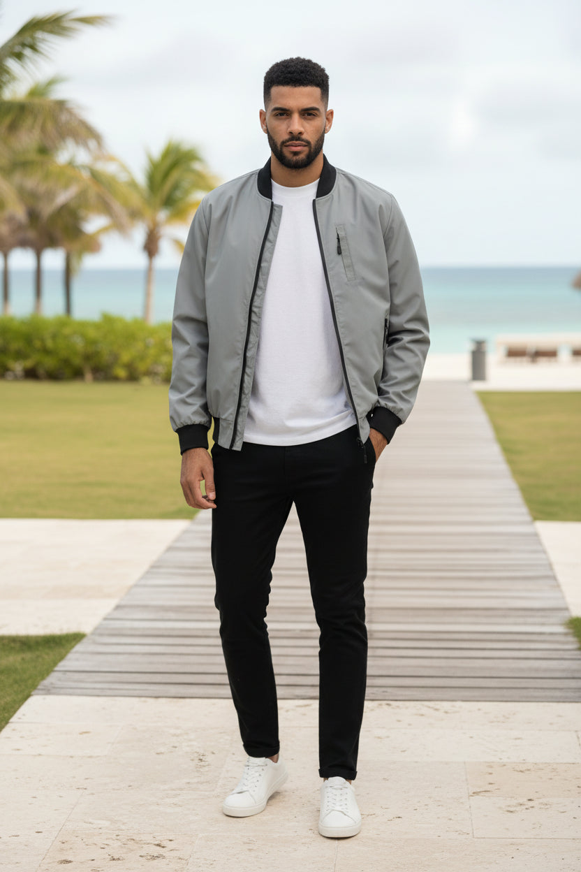 Lightweight grey windbreaker jacket with front zip and black ribbed cuffs