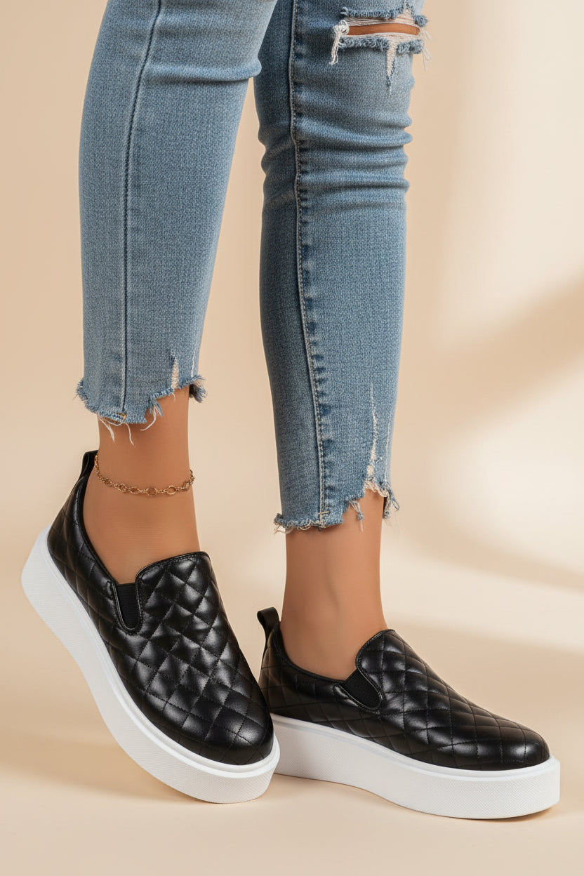 Quilted black slip-on platform sneaker with white sole and rounded toe