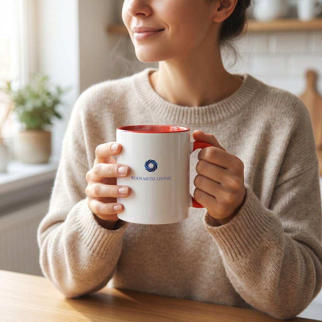 Ceramic mug with red interior and handle, white body with KoolMedz Living logo