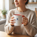 Ceramic mug with red interior and handle, white body with KoolMedz Living logo