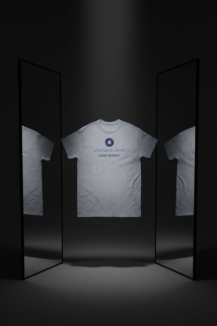 A light heather gray short-sleeve t-shirt with a blue and navy graphic on the chest. The graphic features a circular swirl logo above the text 'KOOLMEDZ LIVING' in light blue and 'LOVE DEEPLY' in navy, displayed on a clean white background.