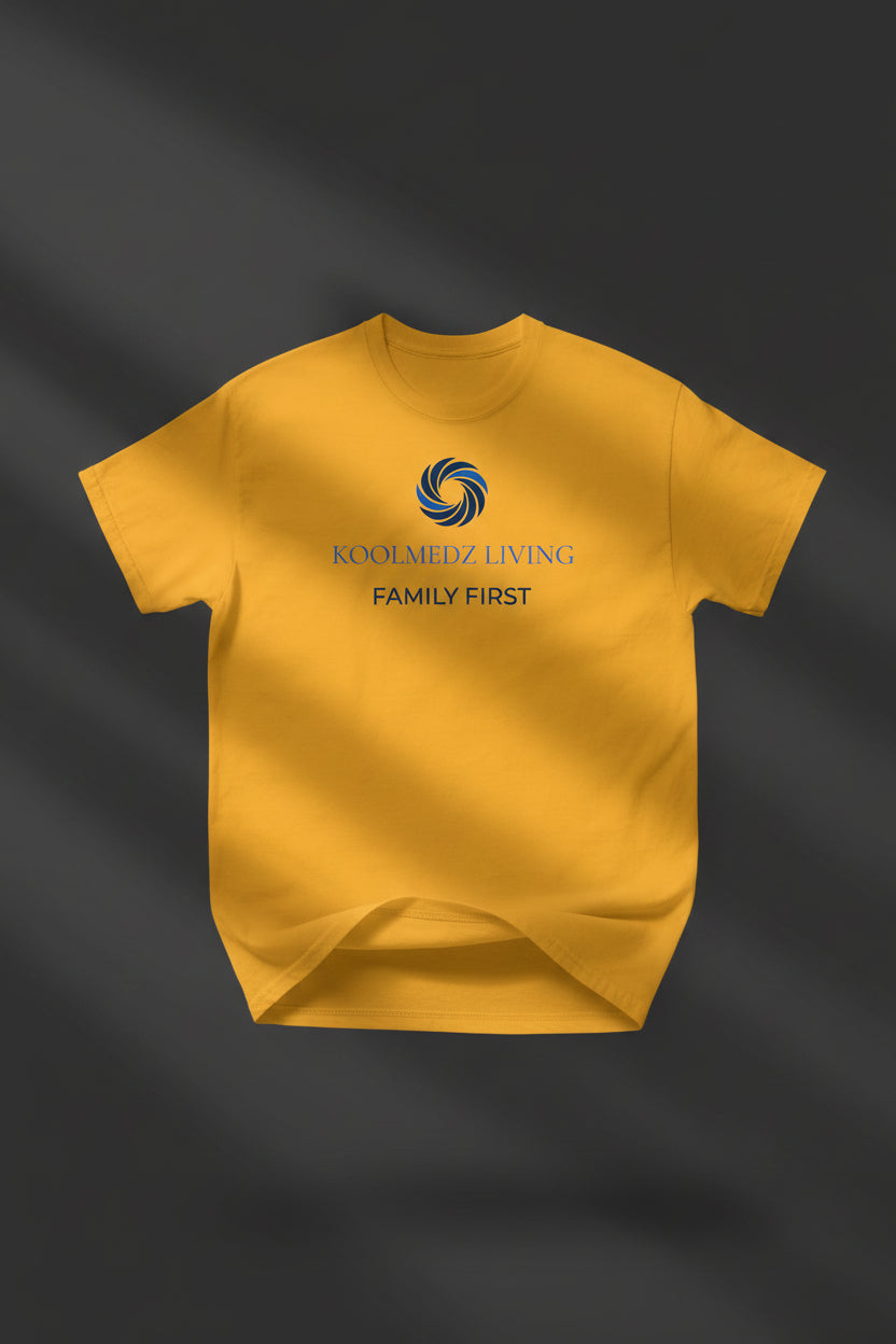 A yellow short-sleeve crewneck t-shirt with a blue and navy graphic on the chest reading 'KOOLMEDZ LIVING' and 'FAMILY FIRST' with a swirl logo.