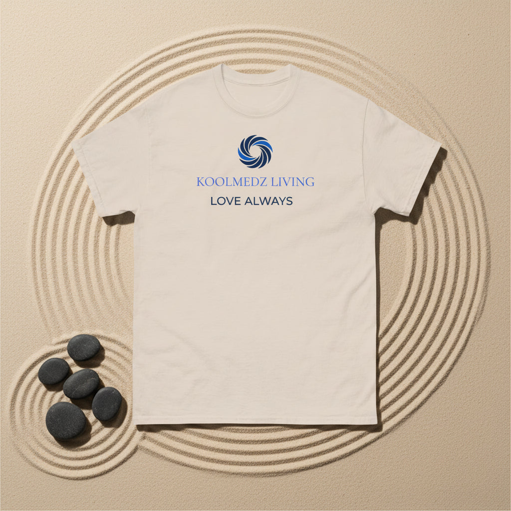 A light beige crewneck t-shirt with a blue and navy graphic on the chest featuring a swirl logo and the text 'KOOLMEDZ LIVING' and 'LOVE ALWAYS'.