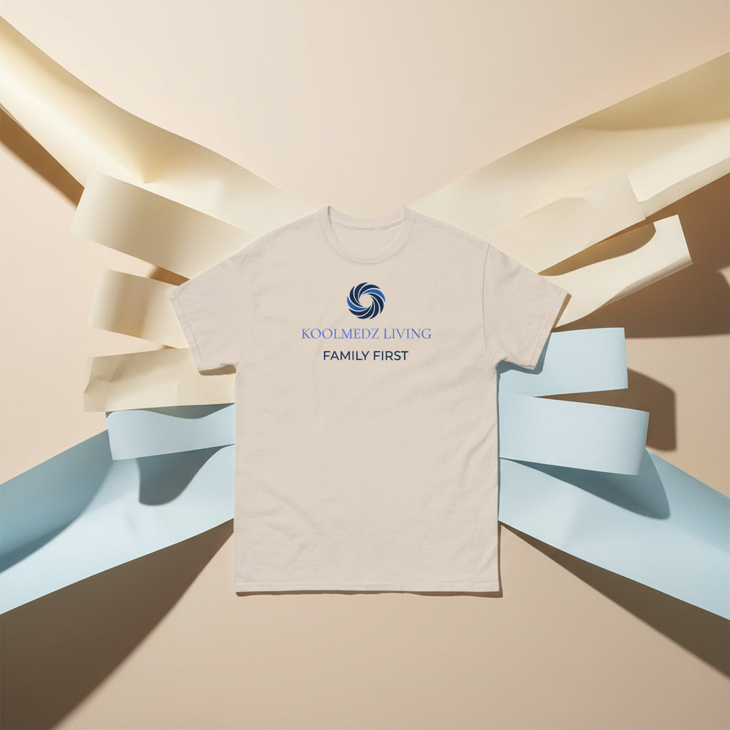 A light beige crewneck t-shirt with a blue and navy graphic on the chest featuring a swirl logo and the text 'KOOLMEDZ LIVING' and 'LOVE DEEPLY'.