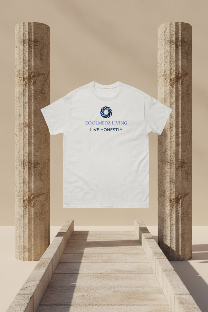 An off-white short-sleeve crewneck t-shirt with a blue and navy graphic on the chest. The graphic features a circular swirl logo above the text 'KOOLMEDZ LIVING' in light blue and 'LIVE HONESTLY' in dark blue.