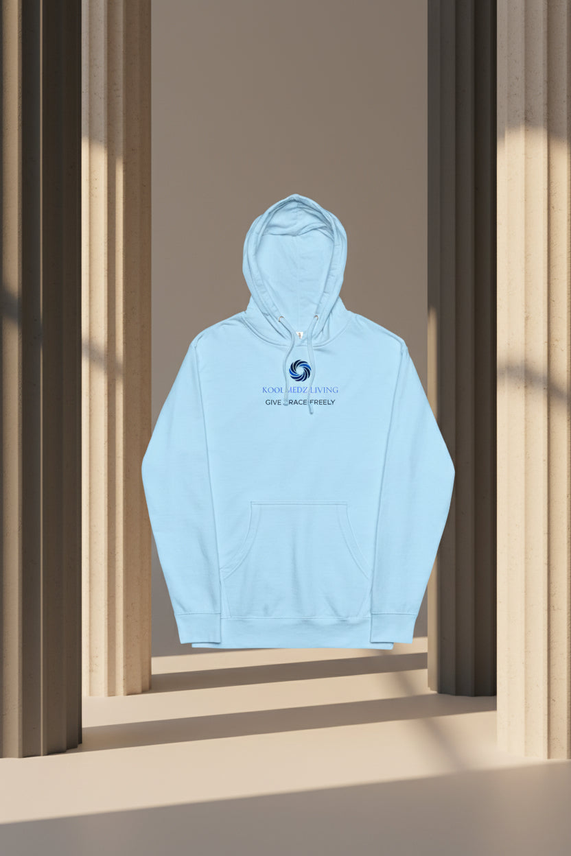 A light blue pullover hoodie with a front kangaroo pocket and a blue graphic on the chest. The graphic features a circular swirl logo above the text 'KOOLMEDZ LIVING' and 'GIVE GRACE FREELY'.