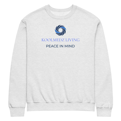 A light heather gray crewneck sweatshirt featuring a blue swirl graphic and the text 'KOOLMEDZ LIVING' and 'PEACE IN MIND' printed on the chest, displayed against a solid white background.