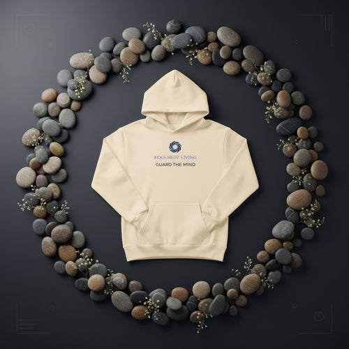 A sandshell pullover hoodie with a front kangaroo pocket, featuring a blue and navy circular logo and the text 'KOOLMEDZ LIVING' and 'GUARD THE MIND' printed on the chest.