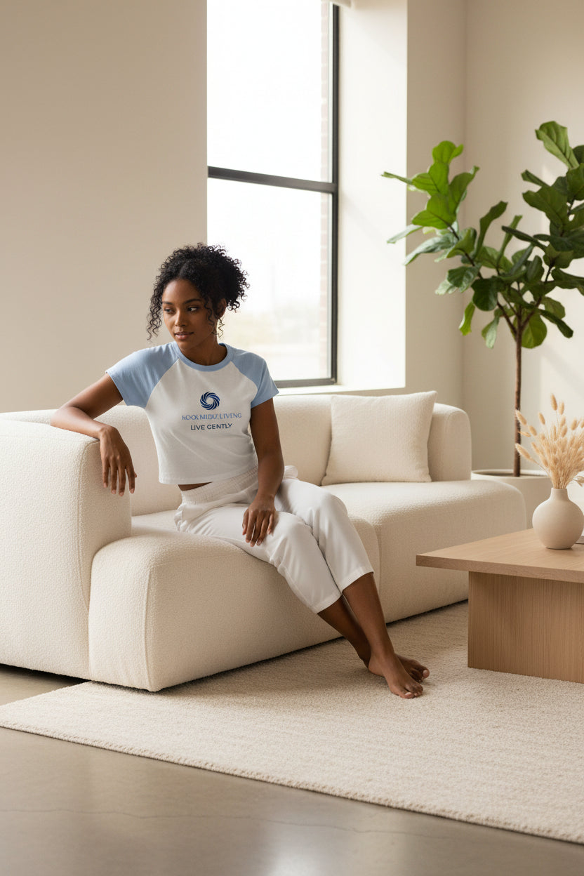 White raglan baby tee with light blue sleeves and front logo graphic