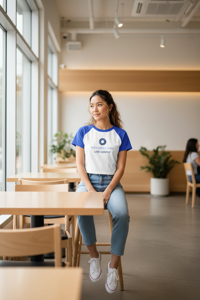 White raglan baby tee with blue sleeves and front logo graphic